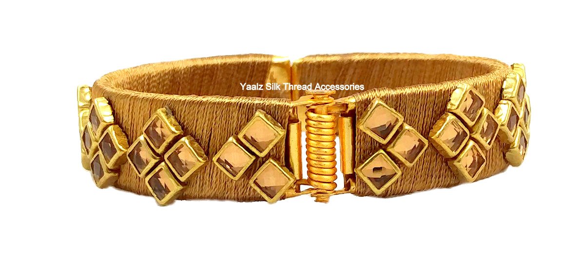 Artistic evil eye gold plated bracelet in brown silk cord -